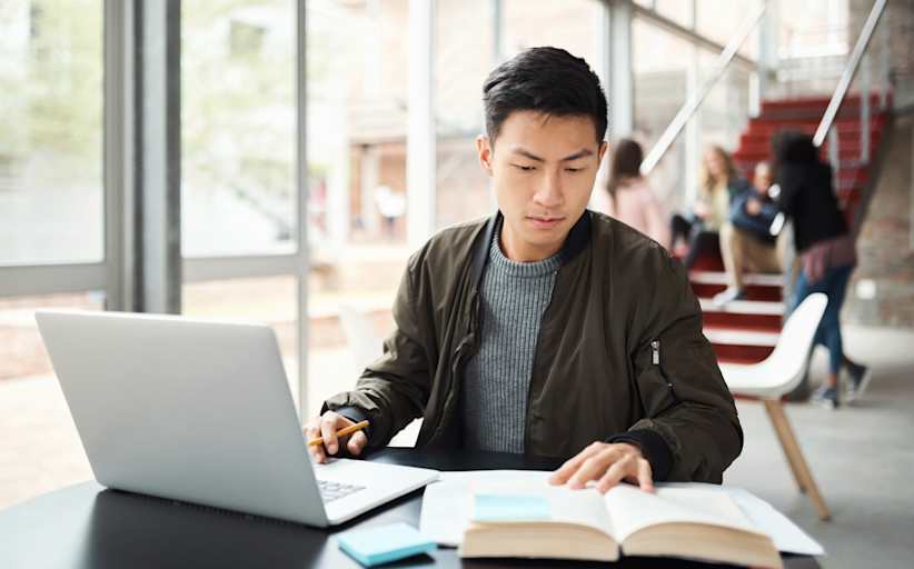 College student looking at textbook