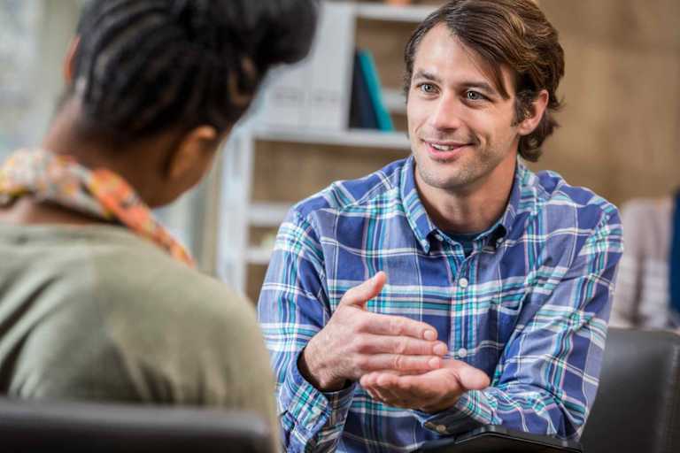Mental health counselor speaking to client