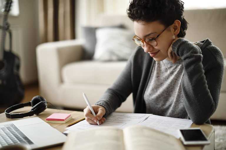 Online counseling student taking notes